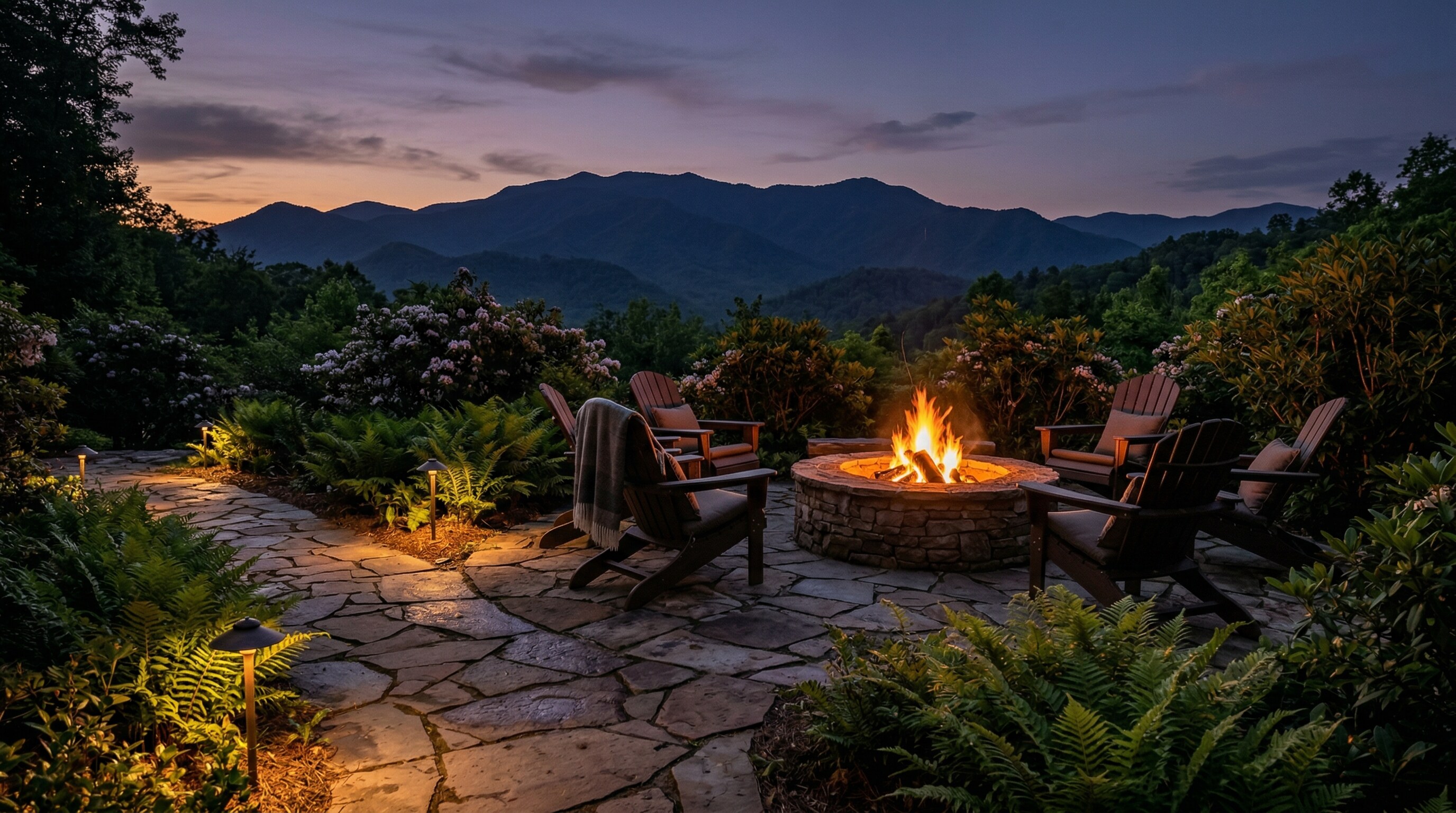 Outdoor living space at twilight with landscape lighting and stone fire pit